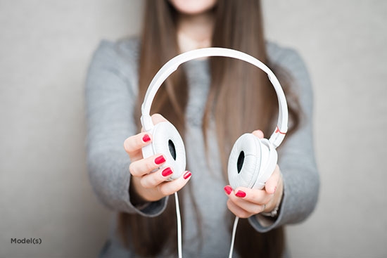 headphones with woman in background
